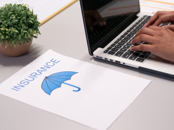 Whats-Changing-in-the-Cybersecurity-Insurance-Market-scaled.jpg Free A Paper beside a Person Typing on a Laptop Stock Photo