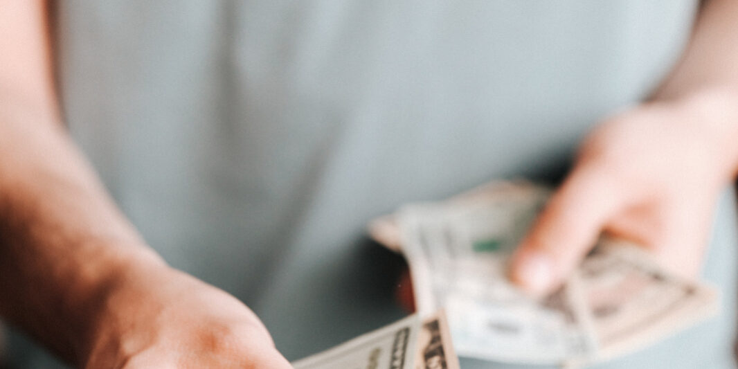 4-Proven-Ways-to-Mitigate-the-Costs-of-a-Data-Breach-resized.jpg Free Crop man paying with American dollars Stock Photo