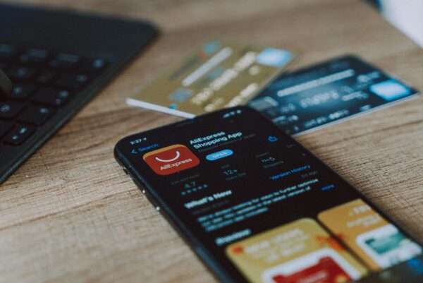 Is-Your-Online-Shopping-App-Invading-Your-Privacy-scaled.jpg black and orange card on brown wooden table