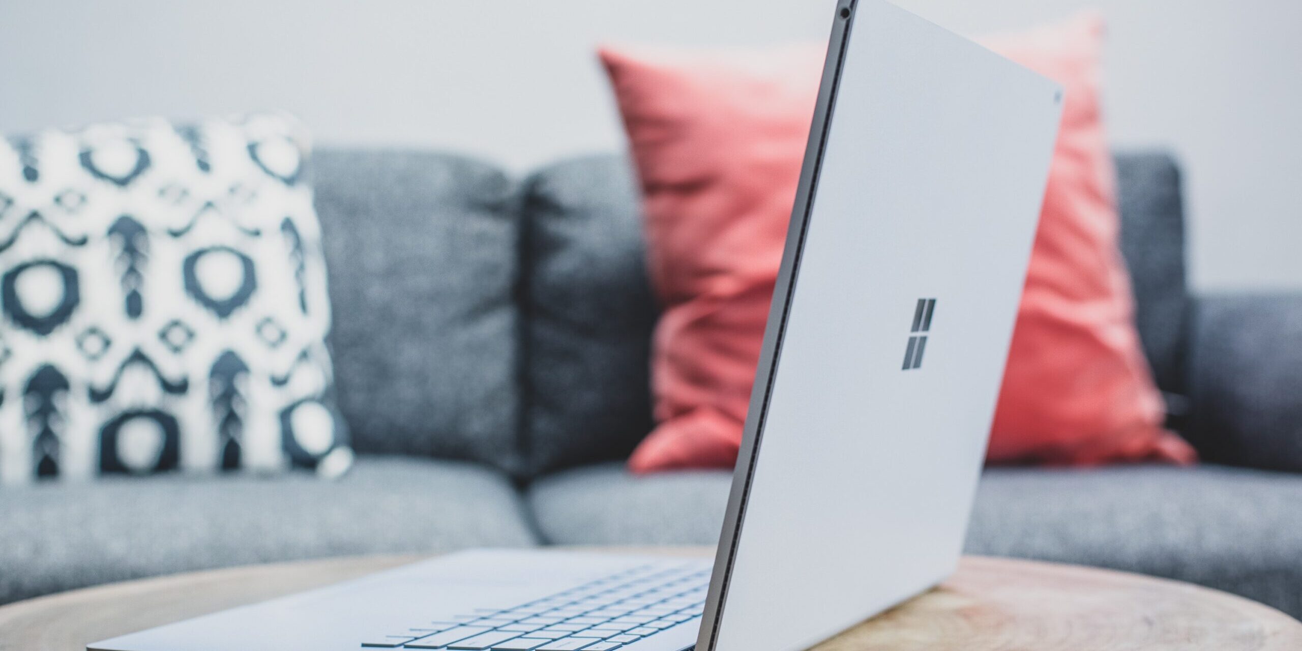Have-You-Tried-Out-Microsoft-Designer-Yet_-Get-the-Scoop-Here-scaled.jpg macbook pro on white couch