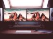 turned on two flat screen computer monitors with speakers