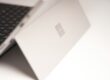 white laptop computer on white table