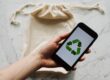 Free Faceless person showing recycle symbol on mobile phone screen Stock Photo