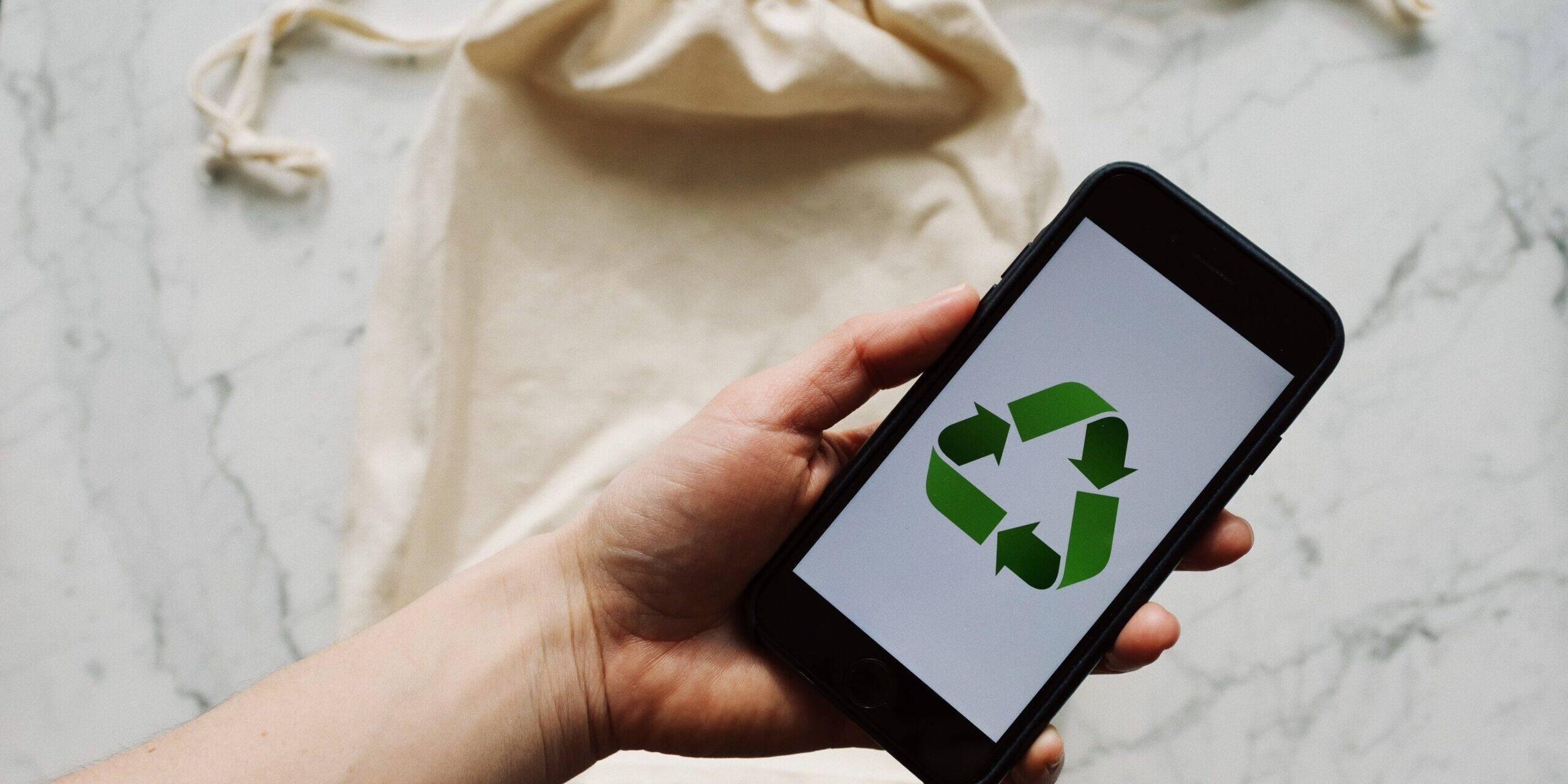 11-Ways-to-Responsibly-Get-Rid-of-E-Waste-at-Your-Home-or-Office-scaled.jpg Free Faceless person showing recycle symbol on mobile phone screen Stock Photo