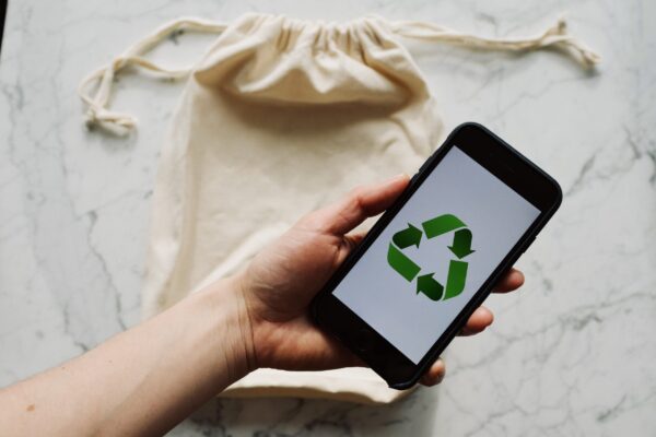 11-Ways-to-Responsibly-Get-Rid-of-E-Waste-at-Your-Home-or-Office-scaled.jpg Free Faceless person showing recycle symbol on mobile phone screen Stock Photo