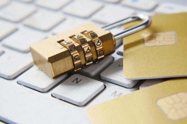 Need-to-Show-the-Tangible-Value-of-Cybersecurity-Heres-How-scaled.jpg a golden padlock sitting on top of a keyboard
